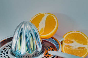 Citrus press with a sliced orange
