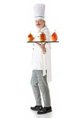 Chef cook in white uniform posing with a fruits on a white background