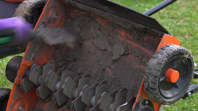 Cleaning a heavily soiled lawn aerator