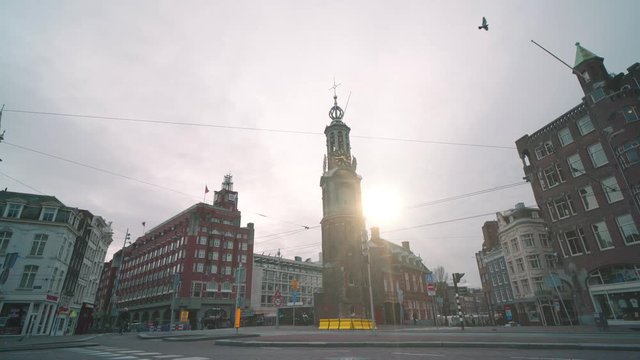 Time lapse of car, tram transport, people and bicycle road traffic in historic center in Amsterdam downtown, Netherlands. City on quarantine due to coronavirus