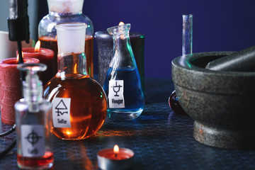Potions and candles on alchemist's table