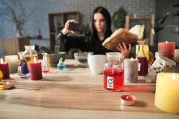 Obraz na płótnie Canvas Female alchemist making elixir in laboratory