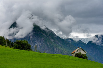 Landscape with old farmhouse and mountains, Norway