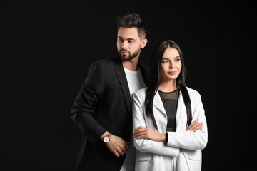 Young couple with beautiful healthy hair on dark background