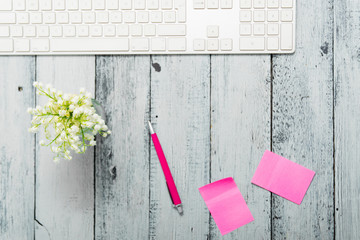 loft style place of work with lily of the valley and pink post its, directly above