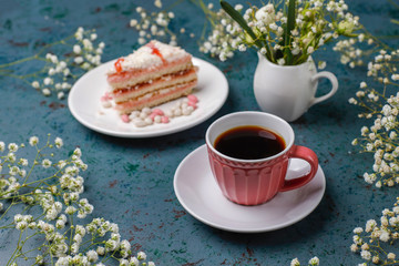 Victoria sponge cake slices with a cup of coffee on light background,top view