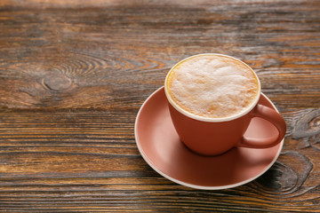 Cup of hot coffee on wooden table