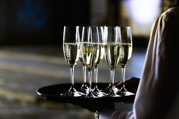 glasses on a tray at the waiter