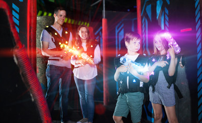 Fototapeta na wymiar Kids in beams during laser tag game