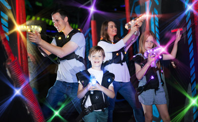 Kids and parents in beams during laser tag game