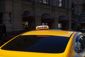 The big taxi sign on the background of night city.