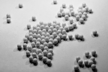 White round pills are scattered on the table. The concept of treatment and recovery