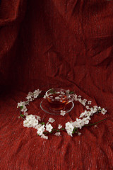 cup of tea and cherry brunches on table