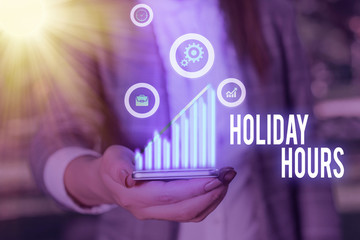 Writing note showing Holiday Hours. Business concept for employee receives twice their normal pay...