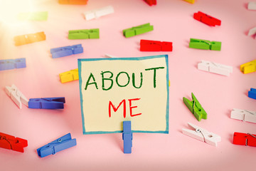 Text sign showing About Me. Business photo text telling someone list of your good and bad traits and past events Colored clothespin papers empty reminder pink floor background office pin