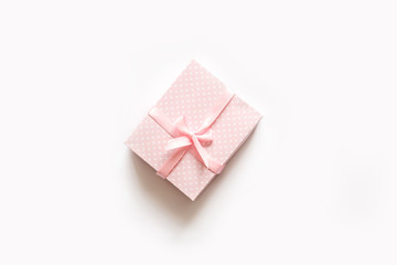 Pink gift box on white top view.