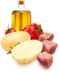 Ingredients for stew. Dices of meat, potatoes, red pepper, olive oil and rosemary. Isolated on white background.