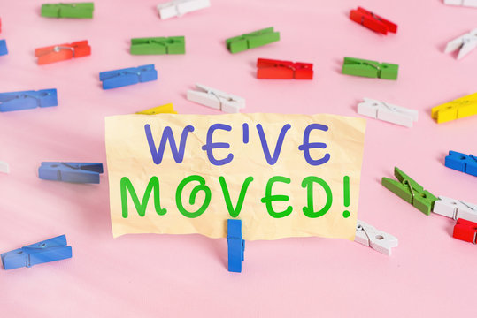Text sign showing We have Moved. Business photo showcasing To go from one residence or location to another Relocate Colored clothespin papers empty reminder pink floor background office pin - Powered by Adobe