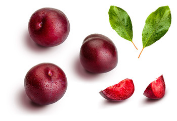 Plums from different angles and leaves isolated on white background. Appetizing and healthy red plums, whole and cut into segments with an aspect of illustration.