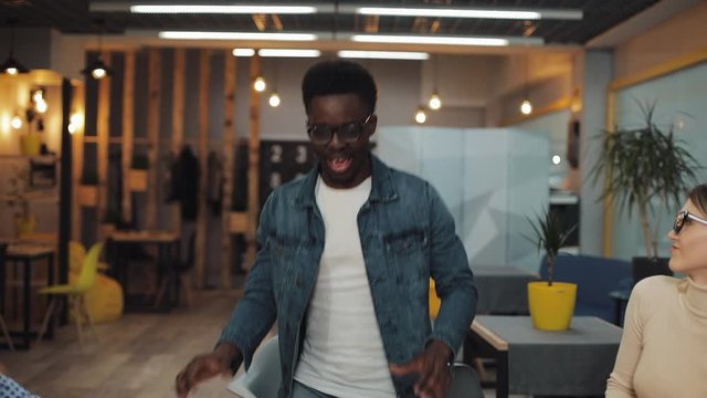 Rain of money. Multi-ethnic business people celebrating victory and having fun at modern business office. People, success business, and fortune concept. Shot on Red Epic.