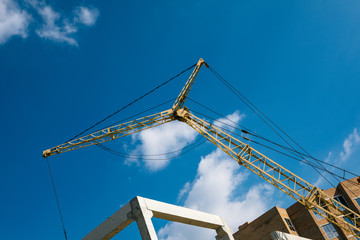 construction site with cranes on blue sky background