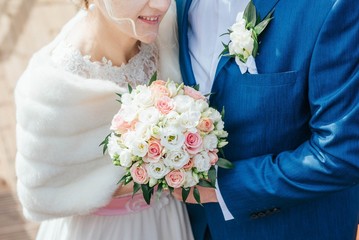 bride and groom with bouquet of flowers