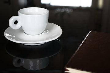 Cup of coffee and notebook on a table, in a stylish business meeting setting