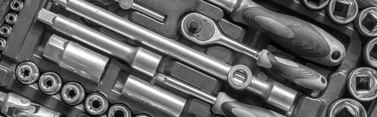 Black and white men tools background. Worker tools and equipment close-up. A set of wrenches and...