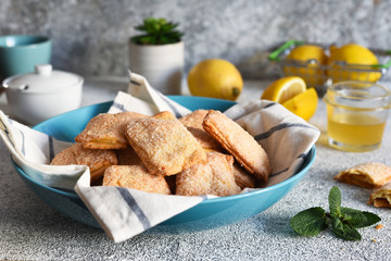 Lemon cookies with sugar and zest on the kitchen table.