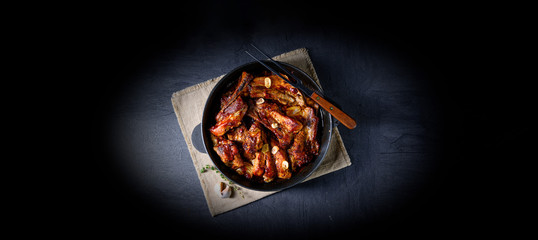Spicy pork ribs with garlic and barbecue sauce - obrazy, fototapety, plakaty