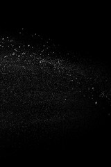 White sugar with flour thrown isolated on black background