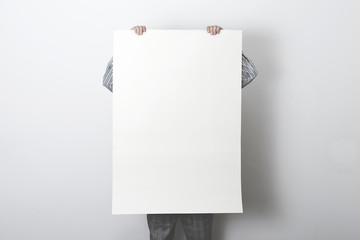 man holding white empty poster