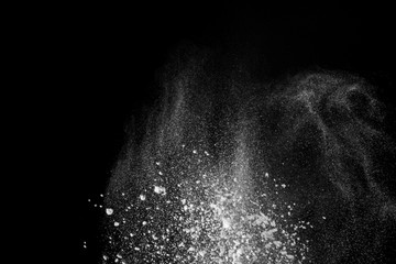 Wonderful pattern of white powder of light snow and flour explodes on black background