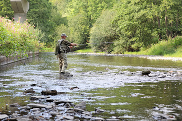 trout fisherman in action on a small river