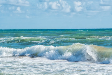 Naklejka na ściany i meble Seascape panorama. Foam sea waves under blue sky. toned image.