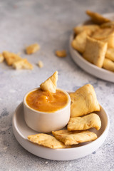 Almogrote , cheese paste, in ceramic bowl and toasts. Typical La Gomera appetizer in many restaurants in Canary Islands made from hard cheese, peppers, olive oil and garlic.
