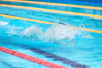 Water splash in swimming pool. Summer vacation holiday.