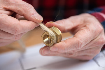 Plumber preparing fitting sealing