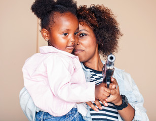 adorable sweet young afro-american mother with cute little daughter, hanging at home, having fun...