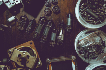 Electronic vacuum tubes and other electronic components on the table.