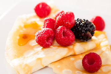 pancakes with raspberries, blackberries and honey