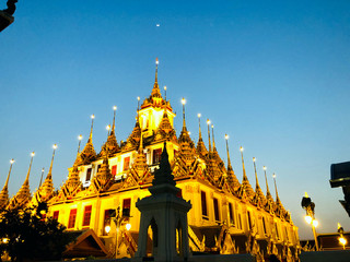 Wat Ratchanadda in the night with half moon and a clear blue sky - Architecture Photography