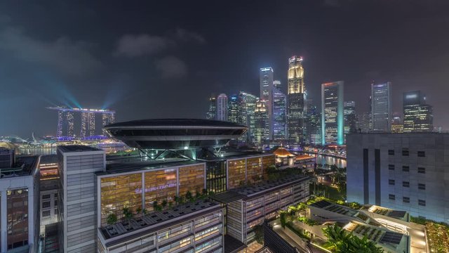Colorful of Singapore Central business district aerial timelapse cityscape skyline at Marina Bay with illuminated Singapore Academy of Law and Parliament House from above