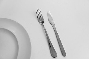 fork and knife with  white plate restaurant food service