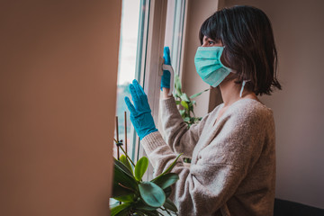 Young woman in medical mask and gloves isolation at home for self quarantine. Stay at ome...