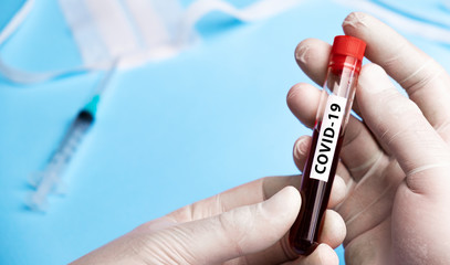 Doctor holding test tube with blood for 2019-nCoV analyzing. Coronavirus disease COVID-19 pandemic