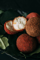 Balls of goat cheese in red pepper. Homemade natural hard cheese on a plate. Farm diet products.