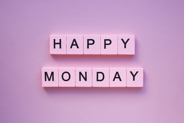 Happy monday words wooden cubes on a pink background