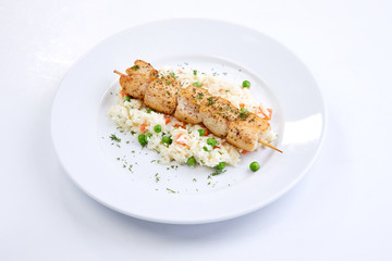 chicken kebab with rice and vegetables on the white background