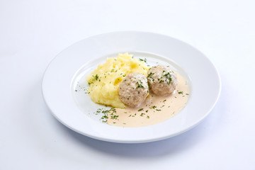 meatballs with mashed potato on the white plate